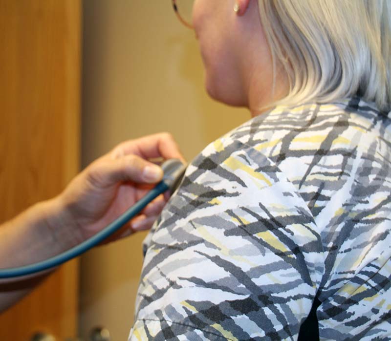 cardiology patient getting heart rate checked with stethoscope 